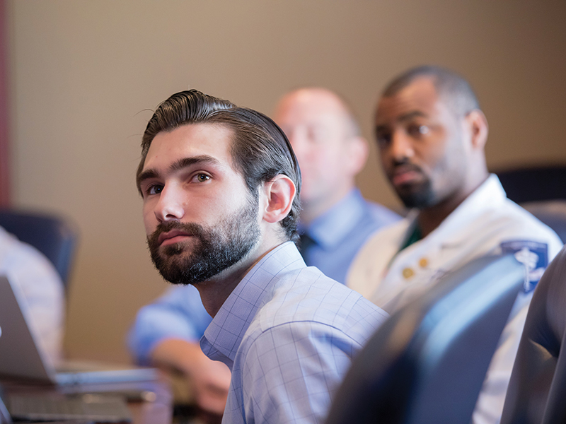 M3s Connor Tierney, foreground, and Nate Hughes are part of an October small group learning session with Dr. David Norris.